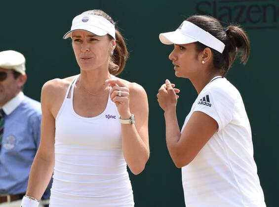 Tennis - 2015 Wimbledon Championships - Week Two, DAY 7 Monday Women s Doubles, fourth Round Martina Hingis and Sania Mirza vs. Anabel Medina Garrigues and Arantxa Parra Santonja Martina Hingis talks to Sania Mirza on Court 6 COLORSPORT ANDREW COWIE 