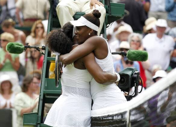 (150706) -- LONDON, July 6, 2015 -- Serena Williams (L) and her sister Venus Williams of the United States hug after their women s singles fourth round match at the 2015 Wimbledon Championships at the All England Tennis Club in Wimbledon, southwest London, Britain on July 6, 2015. Serena Williams won 2-0. ) (SP)UK-LONDON-TENNIS-WIMBLEDON-DAY 7 HanxYan 
