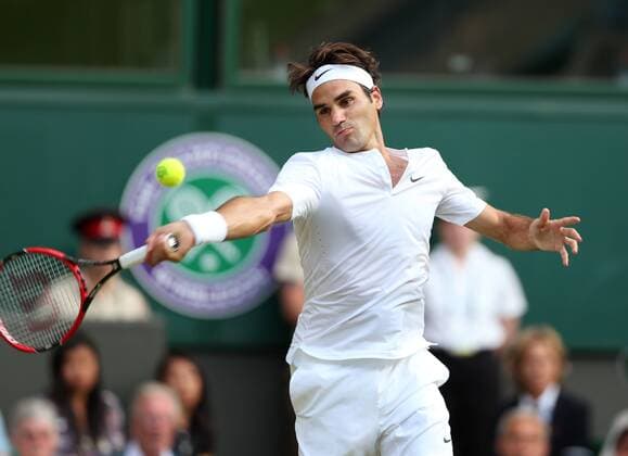 Roger Federer of Switzerland competes during the men s singles fourth round match against Roberto Bautista Agut of Spain at the 2015 Wimbledon Championships at the All England Tennis Club in Wimbledon, southwest London, Britain on July 6, 2015. Roger Federer won 3-0. ) (SP) BRITAIN-LONDON-TENNIS-WIMBLEDON HanxYan 