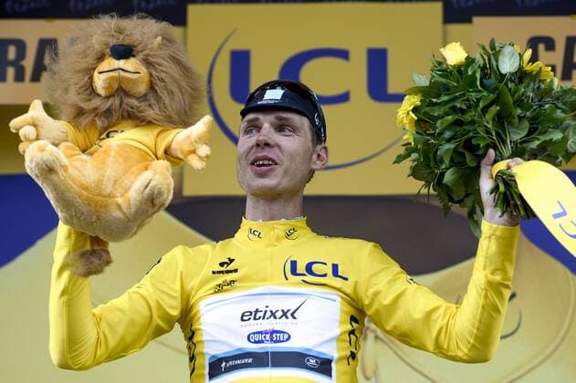 - CAMBRAI, FRANCE: German Tony Martin of team Ettix - Quick-Step celebrates on the podium in the yellow jersey of leader in the overall ranking after stage 4 of the 102nd edition of the Tour de France cycling race, 223,5km from Seraing, Belgium, to Cambrai, France, Tuesday 07 July 2015. This year s Tour de France is taking place from 4 to 26 July. DIRKxWAEM  x04660112x
