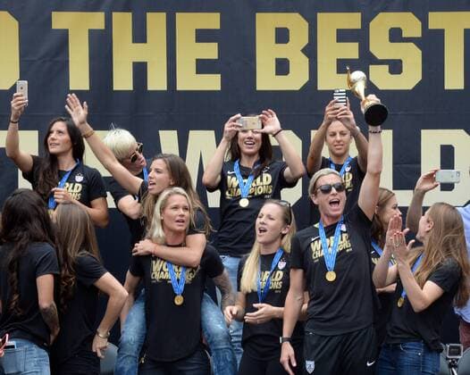 The United States of America women s soccer team lead by Abby Wambach (holding trophy) celebrate their 2015 Women s World Cup victory during a rally at Microsoft Square in Los Angeles on July 7, 2015.  LAP2015060704 JIMxRUYMEN