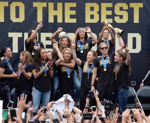 The United States of America women s soccer team lead by Abby Wambach (holding trophy) celebrate their 2015 Women s World Cup victory during a rally at Microsoft Square in Los Angeles on July 7, 2015.  LAP2015060707 JIMxRUYMEN