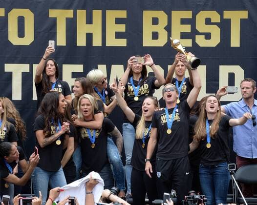 The United States of America women s soccer team lead by Abby Wambach (holding trophy) celebrate their 2015 Women s World Cup victory during a rally at Microsoft Square in Los Angeles on July 7, 2015.  LAP2015070708 JIMxRUYMEN