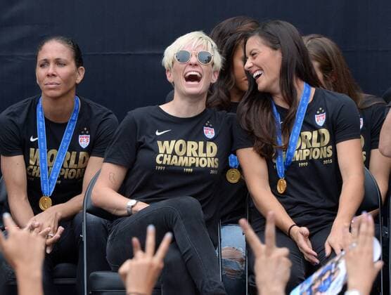 Teammates Megan Rapinoe (L) and Ali Krieeger share a moment as the U.S. women s soccer team celebrate their 2015 Women s World Cup victory during a rally at Microsoft Square in Los Angeles on July 7, 2015.  LAP2015060723 JIMxRUYMEN
