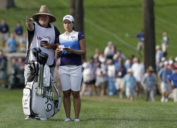 In Gee Chun of Korea stands with caddie Dean Herden in the rough on the 18th hole in the final round of the LPGA Golf Damen U.S. Women s Open Championship at Lancaster Country Club in Lancaster, PA on July 12, 2015. Chun wins the U.S. Women s Open and her first LPGA major championship with a score of 8 under par.  NYP20150712133 JOHNxANGELILLO