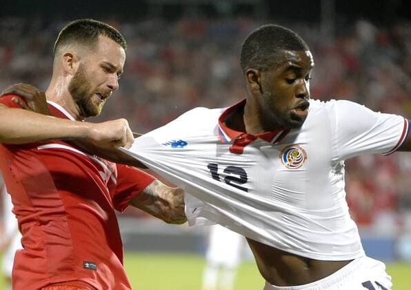 July 14, 2015: Canadian defender David Edgar (5) gets ahold of the shirt of Costa Rica forward Joel Campbell (12) during the second half of a Gold Cup match at BMO Field, Toronto, ON. SOCCER: JUL 14 CONCACAF Gold Cup - Group Stage - Canada v Costa Rica Icon15071413 EDITORIAL USE ONLY