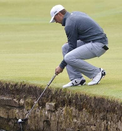 American Jordan Spieth retrieves his ball from the water on the final practice day before the start of the 144th Open Championship, St.Andrews on July 15, 2015.  LON2015071518 HUGOxPHILPOTT