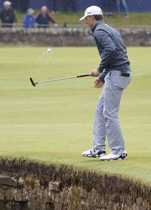 American Jordan Spieth retrieves his ball from the water on the final practice day before the start of the 144th Open Championship, St.Andrews on July 15, 2015.  LON2015071519 HUGOxPHILPOTT