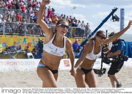 (150722) -- TORONTO, July 22, 2015-- Ana Gallay (L) and Georgina Klug of Argentina celebrate victory after Women s Gold Medal Match of Beach volleyball Beachvolleyball at the 17th Pan American Games in Toronto, Canada on July 21, 2015. Argentina claimed the title after beating Lianma Flores and Leila Martinez of Cuba with 2-1. )(wll) (SP)CANADA-TORONTO-PAN AM GAMES-BEACH VOLLEYBALL ZouxZheng 