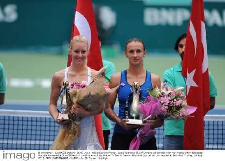 Lesia Tsurenko (L) of Ukraine celebrates with her trophy after defeating Urszula Radwanska (R) of Poland in the final match for the WTA Tennis Damen Istanbul Cup tennis tournament in Istanbul, Turkey, 26 July 2015. 
