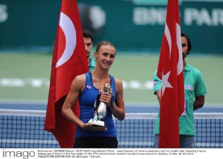 Lesia Tsurenko of Ukraine celebrates with her trophy after defeating Urszula Radwanska of Poland in the final match for the WTA Tennis Damen Istanbul Cup tennis tournament in Istanbul, Turkey, 26 July 2015. 