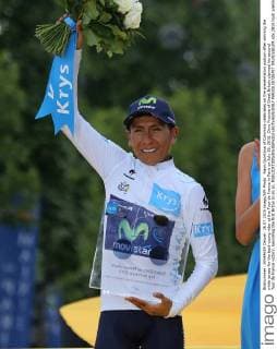 Nairo Quintana of Colombia celebrates on the presentation podium after winning the white jersey for the best young rider at the Tour de France in Paris on July 26, 2015. Chris Froome of Great Britain claimed his second Tour de France victory, becoming the first Briton to do so.  PAR20150726707 DAVIDxSILPA