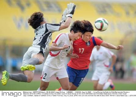(150808) -- WUHAN, Aug. 8, 2015 -- Hong Myong Hui(1st L) of the Democratic People s Republic of Korea (DPRK) competes during the match against South Korea at the 2015 EAFF(East Asian Football Federation) Women s East Asian Cup in Wuhan, capital of central China s Hubei Province, Aug. 8, 2015. DPRK won 2-0 and claimed the title of 2015 EAEF Women s East Asian Cup. ) (SP)CHINA-WUHAN-FOOTBALL-EAFF EAST ASIAN CUP 2015-WOMEN-CHAMPIONSHIP ChengxMin 