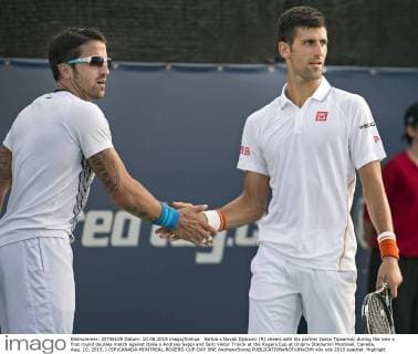 Serbia s Novak Djokovic (R) cheers with his partner Janko Tipsarevic during the men s first round doubles match against Italia s Andreas Seppi and Serb Viktor Troicki at the Rogers Cup at Uniprix Stadiumin Montreal, Canada, Aug. 10, 2015. ) (SP)CANADA-MONTREAL-ROGERS-CUP-DAY ONE AndrewxSoong 