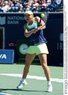 AUG 12, 2015: Simona Halep of Romania returns the ball to Jelena Jankovic of Serbia during their match on day 3 of the Rogers Cup at the Aviva Centre in Toronto, Ontario, Canada. TENNIS: AUG 12 Rogers Cup - Toronto Icon15081297632 EDITORIAL USE ONLY
