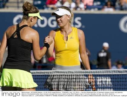 TORONTO, Aug. 12, 2015 -- Caroline Wozniacki (R) of Denmark shakes hands with Belinda Bencic of Switzerland after their women s singles 2nd round match at the 2015 Rogers Cup in Toronto, Canada, on Aug. 12, 2015. Caroline Wozniacki lost 0-2. ) (SP)CANADA-TORONTO-TENNIS-ROGERS CUP-WOMEN S SINGLES ZouxZheng 