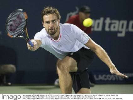 Ernests Gulbis of Latvia hits a return to Novak Djokovic of Serbia during the quarterfinal match at the Rogers Cup in Montreal, Canada, on Aug. 14, 2015. Gulbis lost the match 1-2. ) (SP)CANADA-MONTREAL-ROGERS-CUP-QUARTERFINALS-DJOKOVIC AndrewxSoong 