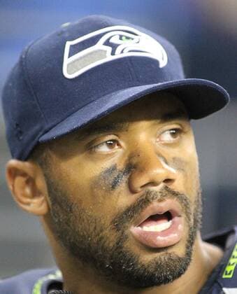 Seattle Seahawks quarterback Russell Wilson watches the game against the Denver Broncos during the fourth quarter at CenturyLink Field on August 14, 2015 in Seattle Washington. The Broncos beat the Seahawks 22-20.  SEA2015081418 JIMxBRYANT