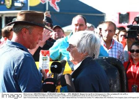 - SPA, BELGIUM: Belgian farmer Erwin Schopgens (L) offers a bottle of milk to F1 s chief executive Bernie Ecclestone during a farmer s protest at the qualification races at the Grand Prix F1 of Belgium, in Spa-Francorchamps, Saturday 22 August 2015. The Spa-Francorchamps Formula One Grand Prix takes place this weekend, from August 21st until August 23rd. GEORGESxDExCOSTER  x04684498x