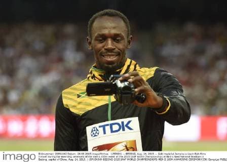 (150824) -- BEIJING, Aug. 24, 2015 -- Gold medalist Jamaica s Usain Bolt films himself during the awarding ceremony of the men s 100m event at the 2015 IAAF Wolrd Championships at Bird s Nest National Stadium in Beijing, capital of China, Aug. 24, 2015. ) (SP)CHINA-BEIJING-2015 IAAF WORLD CHAMPIONSHIPS-MEN S 100M AWARDING CEREMONY(CN) GongxLei 