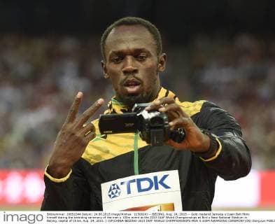(150824) -- BEIJING, Aug. 24, 2015 -- Gold medalist Jamaica s Usain Bolt films himself during the awarding ceremony of the men s 100m event at the 2015 IAAF Wolrd Championships at Bird s Nest National Stadium in Beijing, capital of China, Aug. 24, 2015. ) (SP)CHINA-BEIJING-2015 IAAF WORLD CHAMPIONSHIPS-MEN S 100M AWARDING CEREMONY(CN) GongxLei 