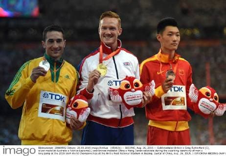 (150826) -- BEIJING, Aug. 26, 2015 -- Gold medalist Britain s Greg Rutherford (C), silver medalist Australia s Fabrice Lapierre(L) and bronze medalist China s Wang Jianan celebrate during the awarding ceremony of men s long jump at the 2015 IAAF World Championships at the Bird s Nest National Stadium in Beijing, capital of China, Aug. 26, 2015. ) (SP)CHINA-BEIJING-IAAF WORLD CHAMPIONSHIPS-MEN S LONG JUMP AWARDING CEREMONY (CN) WangxHaofei 