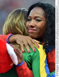 (150827) -- BEIJING, Aug. 27, 2015 -- Gold medalist Cuba s Yarisley Silva (R) hugs with silver medalist Brazil s Fabiana Murer during the women s pole vault awarding ceremony at the IAAF World Championships at the Bird s Nest Naitonal Stadium in Beijing, capital of China, Aug. 27, 2015. ) (SP)CHINA-BEIJING-IAAF WORLD CHAMPIONSHIPS-WOMEN S POLE VAULT AWARDING CEREMONY (CN) LixWen 