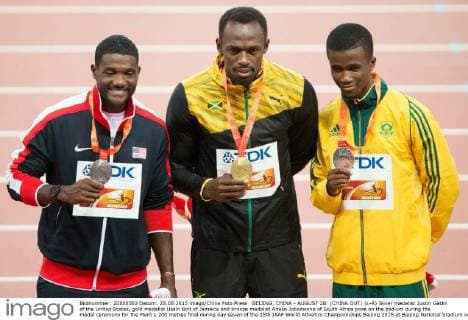 BEIJING, CHINA - AUGUST 28: (CHINA OUT) (L-R) Silver medalist Justin Gatlin of the United States, gold medalist Usain Bolt of Jamaica and bronze medalist Anaso Jobodwana of South Africa pose on the podium during the medal ceremony for the Men s 200 metres final during day seven of the 15th IAAF World Athletics Championships Beijing 2015 at Beijing National Stadium on August 28, 2015 in Beijing, China.  CFP471986683 