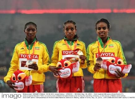 (150830) -- BEIJING, Aug. 30, 2015 -- Gold medalist Ethiopia s Almaz Ayana (C), silver medalist Senbere Teferi (L) and bronze medalist Genzebe Dibaba pose during the awarding ceremony of the women s 5000m event at the 2015 IAAF World Championships at the Bird s Nest National Stadium in Beijing, capital of China, Aug. 30, 2015. ) (SP)CHINA-BEIJING-IAAF WORLD CHAMPIONSHIPS-WOMEN S 5000M AWARDING CEREMONY (CN) YuexYuewei 