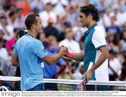 Philipp Kohlschreiber (L) of Germany and Roger Federer of Switzerland meet at the net at the conclusion of their third round match which Federer won in three sets at the US Open Tennis Championships at the USTA Billie Jean King National Tennis Center in New York City on September 5, 2015. Federer won 6-3, 6-4, 6-4.  NYP20150905310 MONIKAxGRAFF