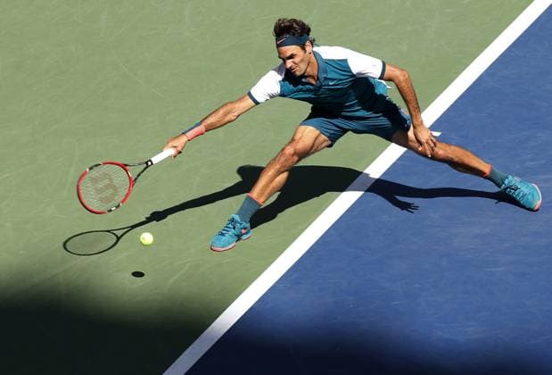 Roger Federer of Switzerland returns the ball to Philipp Kohlschreiber (L) of Germany in the second set of their third round match at the US Open Tennis Championships at the USTA Billie Jean King National Tennis Center in New York City on September 5, 2015. Federer won 6-3, 6-4, 6-4.  NYP20150905315 MONIKAxGRAFF