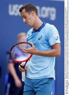 Philipp Kohlschreiber (L) of Germany reacts after losing a point to Roger Federer of Switzerland in the first set of their third round match at the US Open Tennis Championships at the USTA Billie Jean King National Tennis Center in New York City on September 5, 2015. Federer won 6-3, 6-4, 6-4.  NYP20150905322 MONIKAxGRAFF