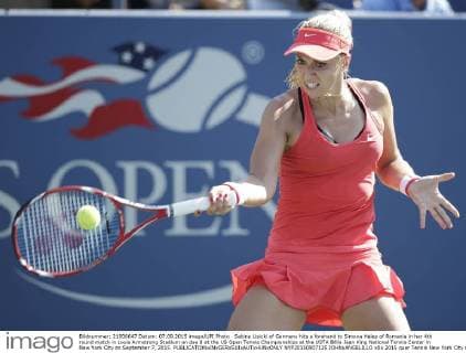 Sabine Lisicki of Germany hits a forehand to Simona Halep of Romania in her 4th round match in Louis Armstrong Stadium on day 8 at the US Open Tennis Championships at the USTA Billie Jean King National Tennis Center in New York City on September 7, 2015.  NYP20150907125 JOHNxANGELILLO