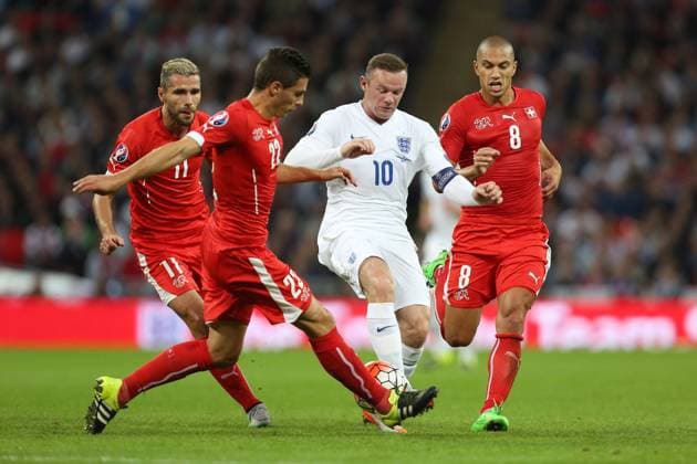 Wayne Rooney of England battles Fabian Schar and Gokhan Inler of Switzerland - England vs Switzerland - UEFA EURO EM Europameisterschaft Fussball 2016 Qualifier - Wembley Stadium - London - 08 09 2015 Pic Philip Oldham SportImage EDITORIAL USE ONLY. No use with unauthorised audio, video, data, fixture lists, club league logos or live services. Online in-match use limited to 120 images, no video emulation. No use in betting, games or single club league player publications.