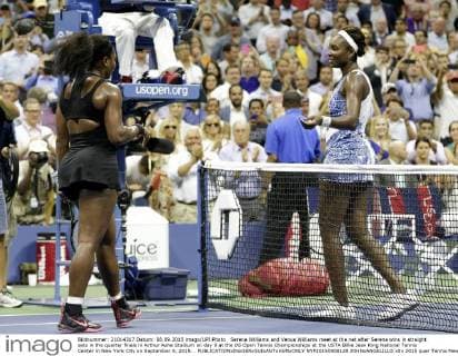 Serena Williams and Venus Williams meet at the net after Serena wins in straight sets in the quarter finals in Arthur Ashe Stadium on day 9 at the US Open Tennis Championships at the USTA Billie Jean King National Tennis Center in New York City on September 8, 2015. .  NYP20150908128 JOHNxANGELILLO