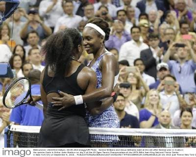 Serena Williams and Venus Williams meet at the net after Serena wins in 3 sets in the quarter finals in Arthur Ashe Stadium on day 9 at the US Open Tennis Championships at the USTA Billie Jean King National Tennis Center in New York City on September 8, 2015. .  NYP20150908129 JOHNxANGELILLO
