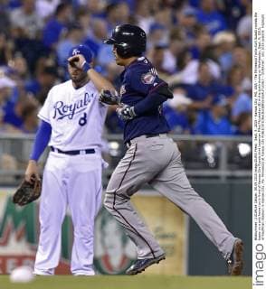 Sept. 9, 2015 - Kansas City, MO, USA - The Minnesota Twins Kurt Suzuki rounds the bases on a solo home run in front of Kansas City Royals third baseman Mike Moustakas (8) in the sixth inning on Wednesday, Sept. 9, 2015, at Kauffman Stadium in Kansas City, Mo. Minnesota at Kansas City - ZUMAm67_