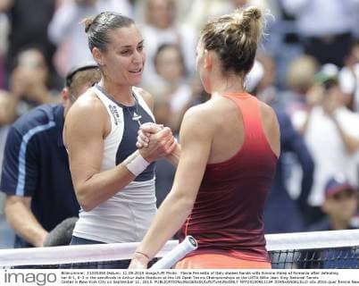 Flavia Pennetta of Italy shakes hands with Simona Halep of Romania after defeating her 6-1, 6-3 in the semifinals in Arthur Ashe Stadium at the US Open Tennis Championships at the USTA Billie Jean King National Tennis Center in New York City on September 11, 2015.  NYP20150911134 JOHNxANGELILLO
