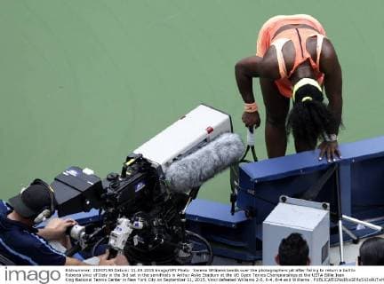 Serena Williams bends over the photographers pit after failing to return a ball to Roberta Vinci of Italy in the 3rd set in the semifinals in Arthur Ashe Stadium at the US Open Tennis Championships at the USTA Billie Jean King National Tennis Center in New York City on September 11, 2015. Vinci defeated Williams 2-6, 6-4, 6-4 and Williams .  NYP20150911137 JOHNxANGELILLO