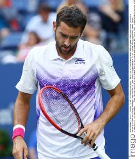 Marin Cilic of Croatia reacts after losing a game to top seed Novak Djokovic of Serbia in the first set of their semi-final match at the US Open Tennis Championships at the USTA Billie Jean King National Tennis Center in New York City on September 11, 2015.Djokovic won 6-0,6-1,6-2.  NYP20150911309 MONIKAxGRAFF