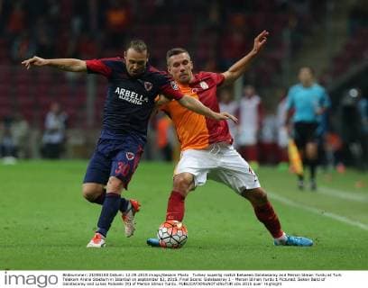 Turkey superlig match between Galatasaray and Mersin Idman Yurdu at Turk Telekom Arena Stadium in Istanbul on september 12, 2015. Final Score: Galatasaray 1 - Mersin Idman Yurdu 1 Pictured: Sekan Balci of Galatasaray and Lukas Podolski (R) of Mersin Idman Yurdu. 