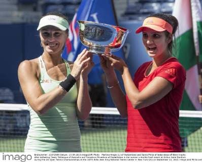 Martina Hingis (L) of Switzerland and Sania Mirza of India show off their trophy after defeating Casey Dellacqua of Australia and Yaroslava Shvedova of Kazakhstan in the woman s double final match at Arthur Ashe Stadium during the US Open Tennis Championships at the USTA Billie Jean King National Tennis Center in New York City on September 13, 2015. Hingis and Mirza won 6-3, 6-3.  NYP20150913302 MONIKAxGRAFF