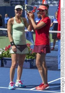 Martina Hingis (L) of Switzerland and Sania Mirza of India show off their trophy after defeating Casey Dellacqua of Australia and Yaroslava Shvedova of Kazakhstan in the woman s double final match at Arthur Ashe Stadium during the US Open Tennis Championships at the USTA Billie Jean King National Tennis Center in New York City on September 13, 2015. Hingis and Mirza won 6-3, 6-3.  NYP20150913303 MONIKAxGRAFF