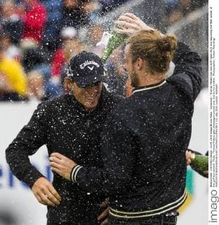 Zandvoort - Thomas Pieters has won KLM Open 2015 and becoming the 96th winner of the golf tournament. Photo: Thomas Pieters gets champagne poured over him by his brother. Photographer: Robert Meerding 
