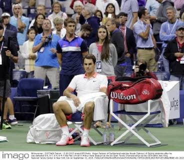 Roger Federer of Switzerland watches Novak Djokovic of Serbia celebrate after he was defeated 6-4, 5-7, 6-4, 6-4 in the Men s Final in Arthur Ashe Stadium at the US Open Tennis Championships at the USTA Billie Jean King National Tennis Center in New York City on September 13, 2015.  NYP20150913828 RAYxSTUBBLEBINE