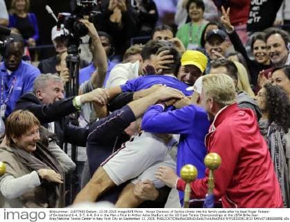 Novak Djokovic of Serbia climbs into his family seats after he beat Roger Federer of Switzerland 6-4, 5-7, 6-4, 6-4 in the Men s Final in Arthur Ashe Stadium at the US Open Tennis Championships at the USTA Billie Jean King National Tennis Center in New York City on September 13, 2015.  NYP20150913833 RAYxSTUBBLEBINE