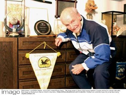 File photo taken in March 2012 shows Dettmar Cramer posing for a photo with gifts from Japan at his home in Reit im Winkl in Germany. 