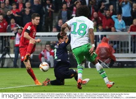 MUNICH, Sept. 22, 2015 -- Bayern s Robert Lewandowski (L) shoots during the German Bundesliga soccer match between FC Bayern Munich and VfL Wolfsburg at the Allianz Arena stadium in Munich, Germany, Sept. 22, 2015. Lewandowski made Bundesliga history on Tuesday after scoring five goals in the space of nine minutes as Bayern Munich rout Wolfsburg 5-1. ) (SP)GERMANY-MUNICH-SOCCER PhilippexRuiz 