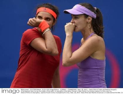 (150926) -- GUANGZHOU, Sept. 26, 2015 -- Sania Mirza of India and Martina Hingis(R) of Switzerland react during the double s final match of Guangzhou Internationl Women s Open Tennis Tournament against Xu Shilin and You Xiaodi of China in Guangzhou, capital of south China s Guangdong Province, Sept. 26, 2015. Sania Mirza and Martina Hingis won 2-0 and claimed the title. ) (SP)CHINA-GUANGZHOU-TENNIS-INTERNATIONAL WOMEN S OPEN-FINAL LiangxXu 