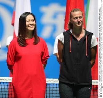 Retired Chinese tennis star Li Na, left, and Czech tennis star Petra Kvitova pose at the opening ceremony of the 2015 WTA Tennis Damen Wuhan Open tennis tournament and the 15,000-seat stadium at the Optics Valley International Tennis Center in Wuhan city, central China s Hubei province, 27 September 2015. China s two-time Grand Slam winner Li Na opened a new 15,000-seat stadium at the Wuhan Open in central China Sunday (27 September 2015) to huge cheers from her hometown fans. The new stadium has been built on the back of Li s career success, she was the first Asian to win a Grand Slam singles, that saw the popularity of tennis surge in China. Huge applause echoed through the stadium as Li, now retired, stepped onto the court wearing a red dress and was joined by the tournament s defending champion Petra Kvitova to open the new stadium officially. Similar in capacity to Wimbledon s centre court, the new stadium is dwarfed only by the US Open s Arthur Ashe stadium which has a capacity of 23,000. It has a retractable roof and a metal and glass structure reminiscent of the iconic bird s nest stadium in Beijing, the centrepiece of the 2008 Olympics. Li Na thrills fans at Wuhan stadium opening  20150927_66314